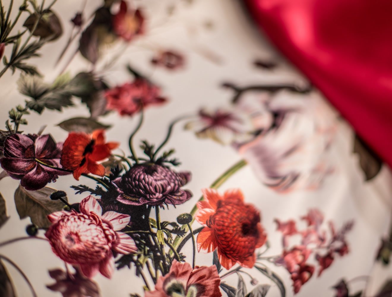 Tela blanca estampada con flores rojas y bordó